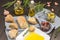 Olive oil in white plate with slice of bread and sprig of thyme