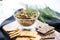 olive tapenade in a glass bowl with whole grain crackers