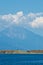 Olive trees on a small island in front of the holy mountains Athos