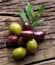 Olive twig and olives on old wooden table.