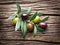 Olive twig on wooden table.