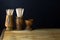 OLIVE WOOD CONTAINERS WITH SHARP WOODEN TOOTHPICKS ON A WOODEN BOARD