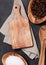 Olive wood kitchen utensils with chopping board and bowl on stone table background. Top view.