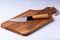 Olive wooden cutting Board with japanese knife on white background