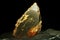 olivenit is a rare precious natural stone on a black background. AI generated.