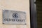 Oliver Grant text and logo sign front of store luxury fashion shop on entrance wall
