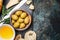 Olives appetizer with cheese, oil and ciabatta gut slices on dark rustic background, top view