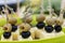 Olives and black olives with cheese on skewers. Festive serving in portions. Close-up