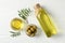 Olives, bottle and bowl with olive oil on background, top view