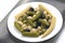 Olives, pickled cucumber, mushrooms and corn in a salad on a plate. food and vegetables. diet and weight loss