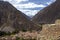 Ollantaytambo ruins, a massive Inca fortress with large stone terraces on a hillside, tourist destination in Peru