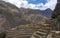 Ollantaytambo ruins, a massive Inca fortress with large stone terraces on a hillside, tourist destination in Peru