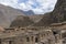 Ollantaytambo ruins, a massive Inca fortress with large stone terraces on a hillside, tourist destination in Peru