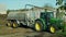 OLOMOUC, CZECH REPUBLIC, AUGUST 21, 2018: Tractor John Deere special trailer spreading fertilizer of slurry on field