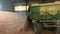 OLOMOUC, CZECH REPUBLIC, JULY 27, 2017: Tractor arrives in the warehouse and pouring harvested wheat grain