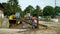 OLOMOUC, CZECH REPUBLIC, JUNE 11, 2019: Cows cowshed cleaning from manure and faeces, budozer JCB and farm worker with