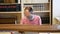 OLOMOUC, CZECH REPUBLIC, JUNE 29, 2020: Coronavirus mask face library student studying or learning in university book