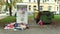 OLOMOUC, CZECH REPUBLIC, OCTOBER 20, 2017: Authentic homeless poor woman looking eats food from trash bin and the