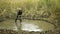 OlOMOUC, CZECH REPUBLIC, OCTOBER, 20, 2022: Swamp dig hoe worker man puddle protection conservation nature out build
