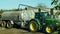 OLOMOUC, CZECH REPUBLIC, OCTOBER 24, 2018: Tractor John Deere special trailer spreading fertilizer of slurry on field