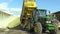 Olomouc, Czech Republic, September 4, 2016: Corn silage pile in concrete pit, John Deere special tractor plus Wagon