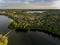 Olsztyn Lake Dlugie, bird`s eye view. Wooded shores, the sky reflecting in the water table and a bridge over the lake - Warmia and