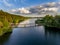 Olsztyn Lake Dlugie, bird`s eye view. Wooded shores, the sky reflecting in the water table and a bridge over the lake - Warmia and