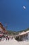 Oludeniz, Turkey - July 10, 2012: tourists walking in town, man landing in parachute on oludeniz beach in summertime