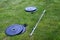 Olympic barbell with black weight plates on a green lawn, ready for an outdoor workout