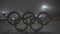 Olympic games logotype at Olympic Park in Munich, Germany in winter on a snowy evening. Olympia rings in snow in a park
