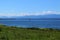 Olympic mountain range and Puget Sound view across a field on Whidbey Island