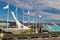 Olympic torch in Sochi on the background of mountains with flags of countries and stands on a sunny day.