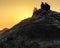 OM BEACH,GOKARNA,KARNATAKA/INDIA-FEBUARY 2, 2018:Young men sit on a hill of rocks,watching the sunset.