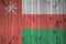 Oman flag depicted in bright paint colors on old wooden wall. Textured banner on rough background