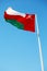 in oman waving flag and the cloudy sky