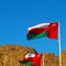 in oman waving flag and the cloudy sky mountain
