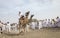 omani men racing on camels