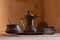 Omani style coffee pot and bowls in front of brown clay wall