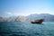 An Omani traditional dhow boat sailing across Musandam sea.