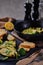 Omelet with broccoli and green onions on a black plate and frying pan on a black background close up