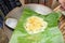 Omelet with green onion in a banana leaf on pan breakfast Asian food Khai-Pam fried egg omelet without oil
