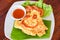 Omelet roll with sliced tomatoes salad lettuce vegetable on white plate - eggs omelette breakfast and tomatoes sauce on top