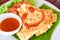 Omelet roll with sliced tomatoes salad lettuce vegetable on white plate - eggs omelette breakfast and tomatoes sauce on top