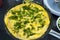 Omelet scrambled eggs with chives and herbs