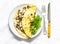 Omelet with shiitake and eringi mushrooms - delicious, healthy, vegetarian brunch on a light background, top view