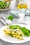 Omelet with spinach leaves. Omelette on plate, scrambled eggs