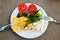 Omelet with tomatoes, dill, cheese and mushrooms on a plate