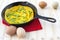 Omelette in cast iron skillet on wood background