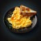 Omelette and fried toast on a black plate on a dark background. Generative AI content.