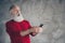 Omg x-mas discounts. Funky modern hipster old man use cellphone browse find noel newyear ads miracle greeting wear red